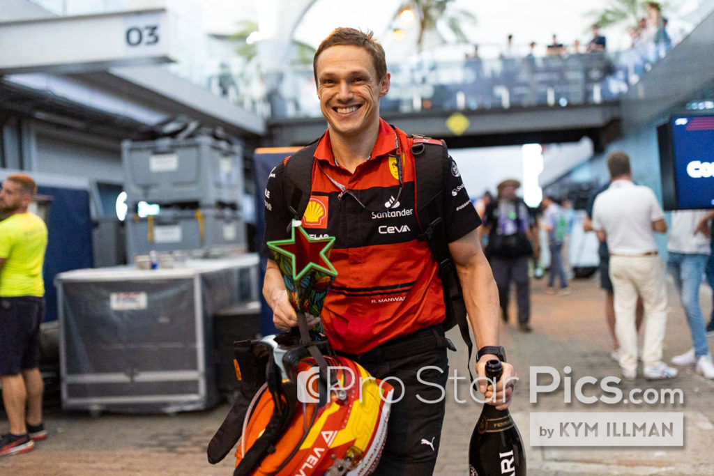 Rupert Manwaring F1 driver F1 trainer carrying Carlos Sainz trophy