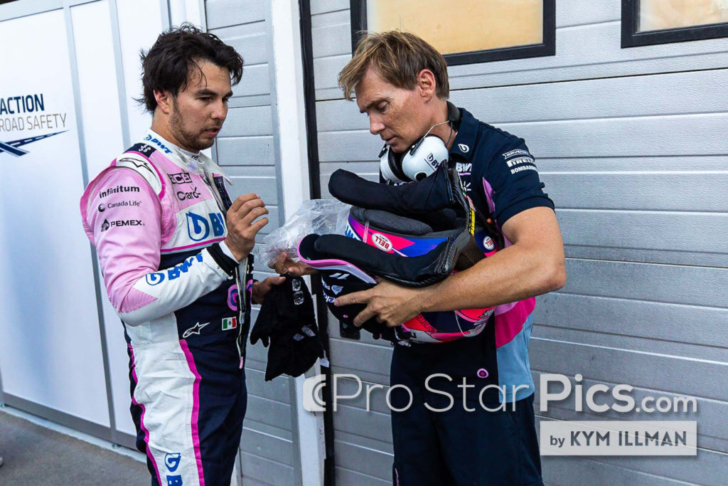 Sergio-Perez-Trainer-Xavi-Martos holding his race equipment after Grand prix