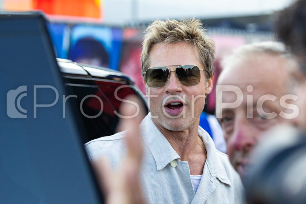 Brad Pitt poses for selfies with fans at the 2023 Silverstone GP 