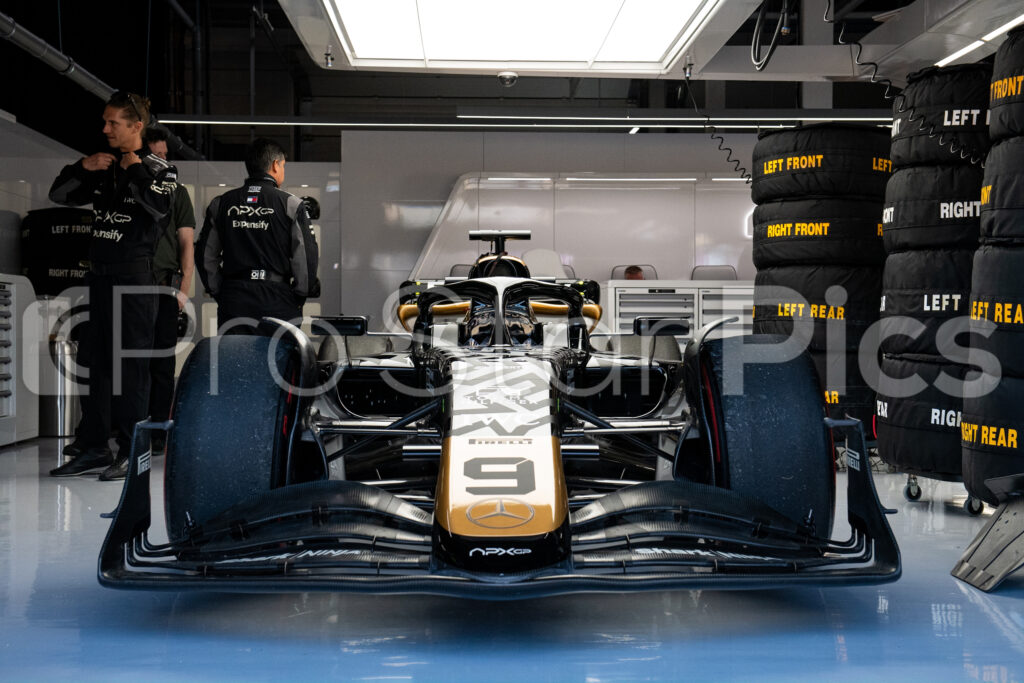 Fictional team APX's F1 car in the APX garage F1 movie behind the scenes