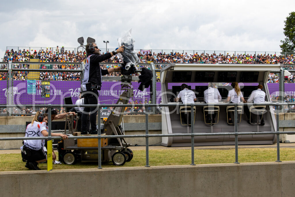 F1 movie behind the scenes film crew in pit lane during the Silverstone GP