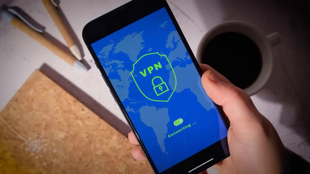 Hand holding a smartphone showing a VPN connecting screen