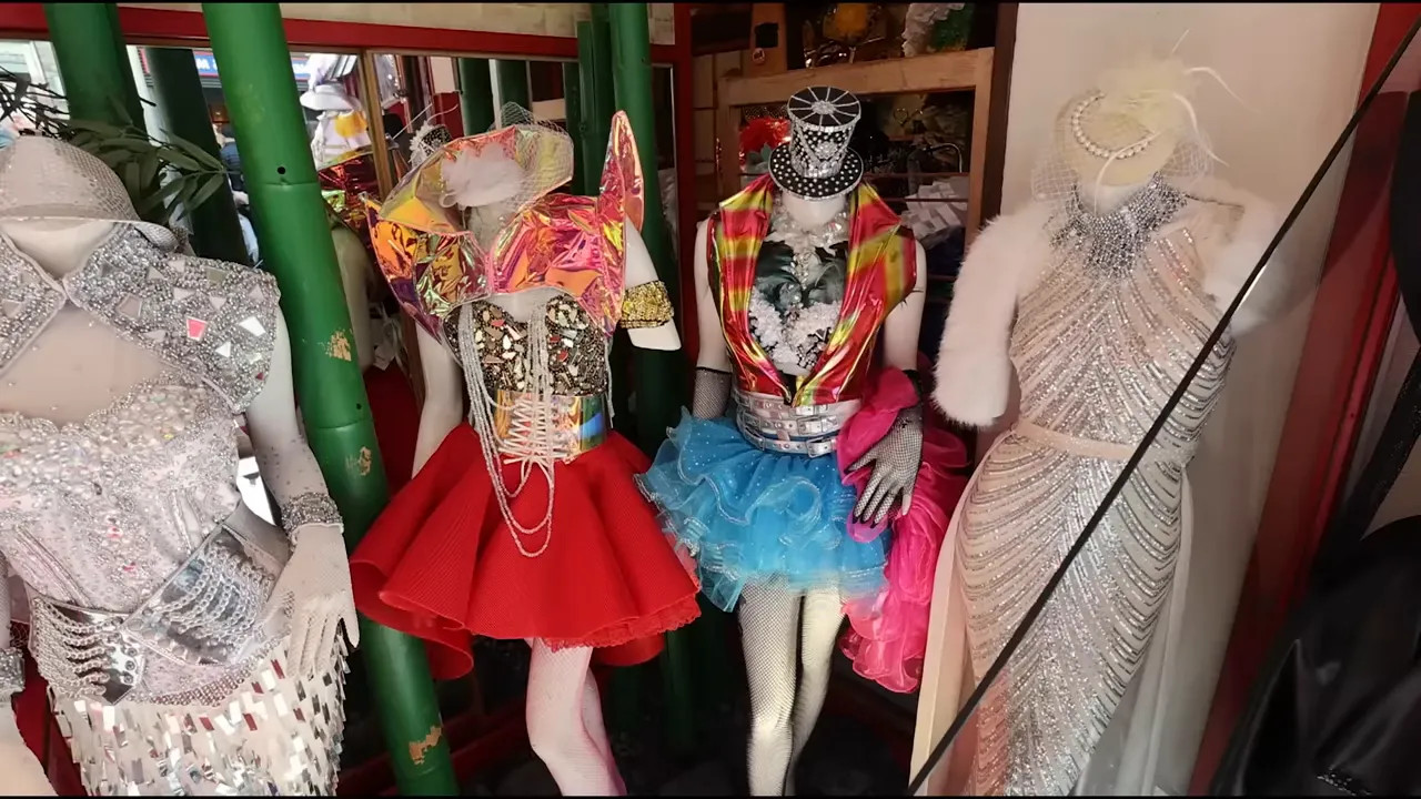 Harajuku clothing store window display with colorful mannequins and sequined outfits