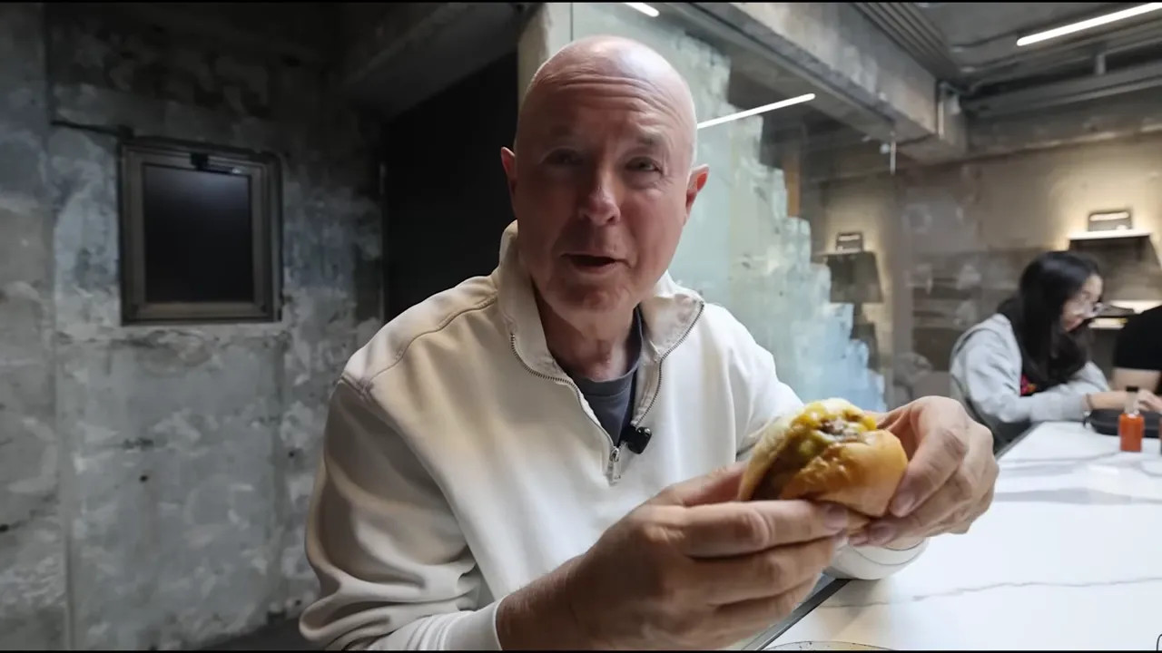 Holding a wagyu burger with cheese in Tokyo