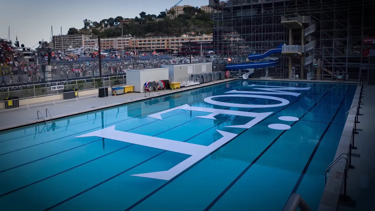 Monaco swimming pool with large white Moet lettering across the blue water