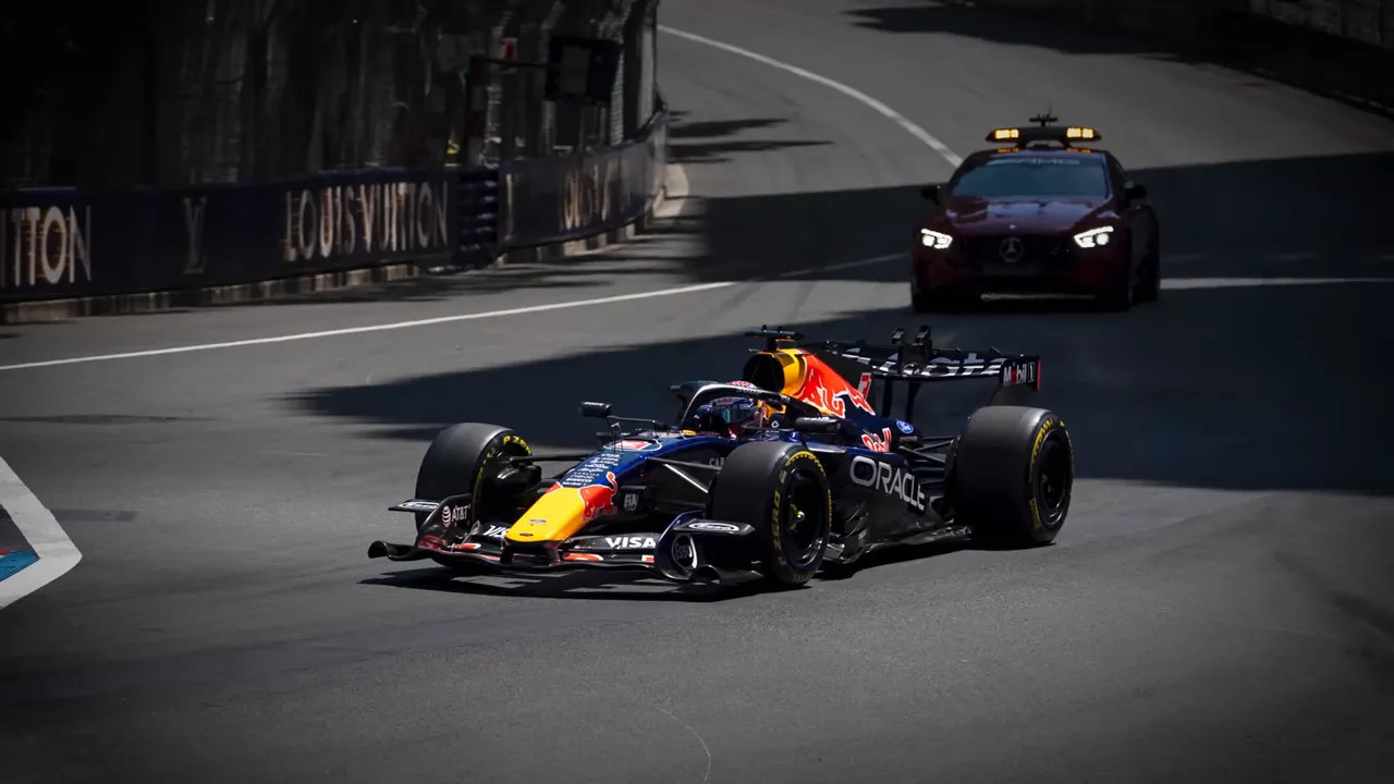 Red Bull Formula 1 car moving slowly alone on the Monaco circuit with a support vehicle behind