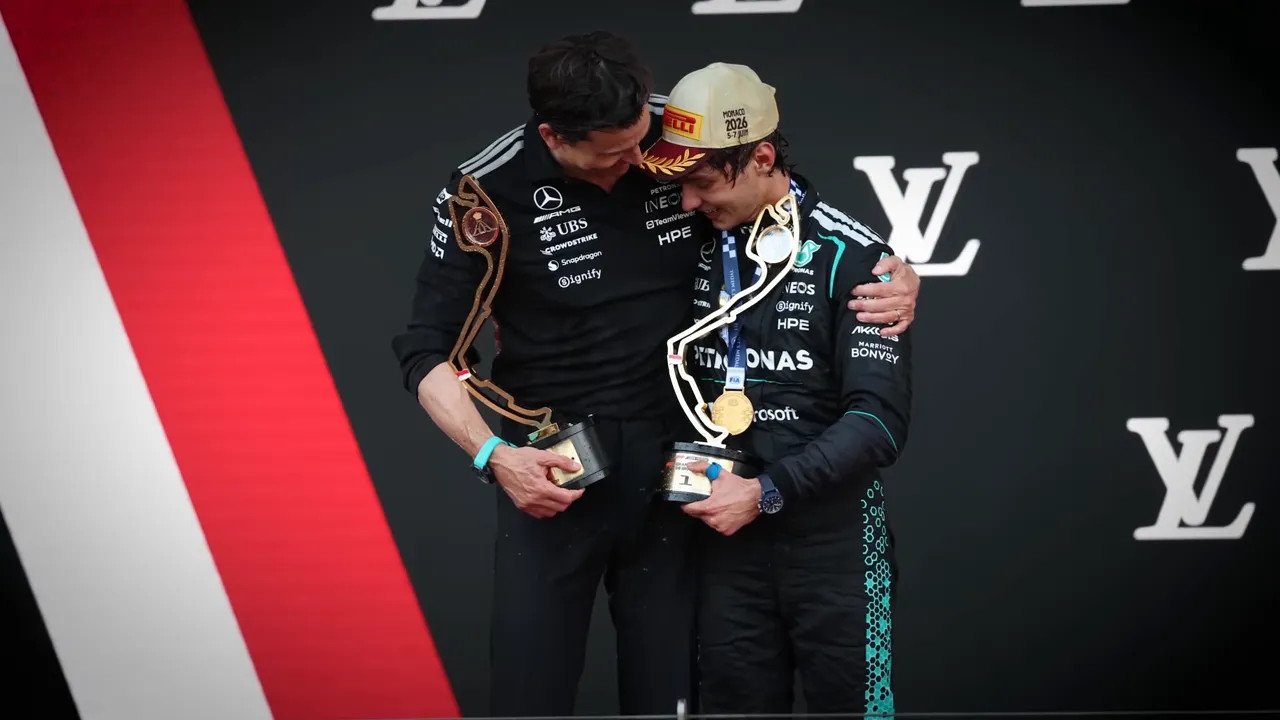 Toto Wolff, Kimi Antonelli, Lewis Hamilton, and Max Verstappen posing together on the Monaco podium