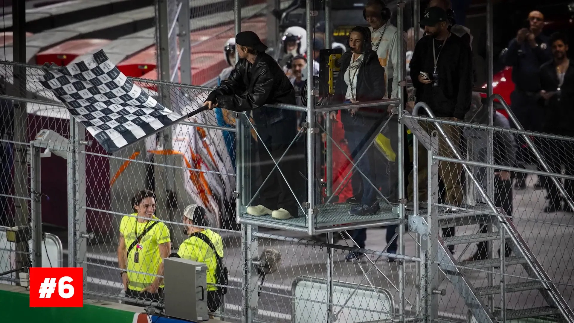 Checkered flags being waved at the race finish