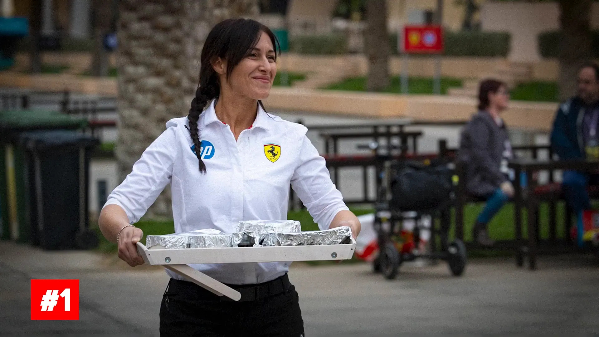 Trainer carrying plated meal into a restaurant near the circuit