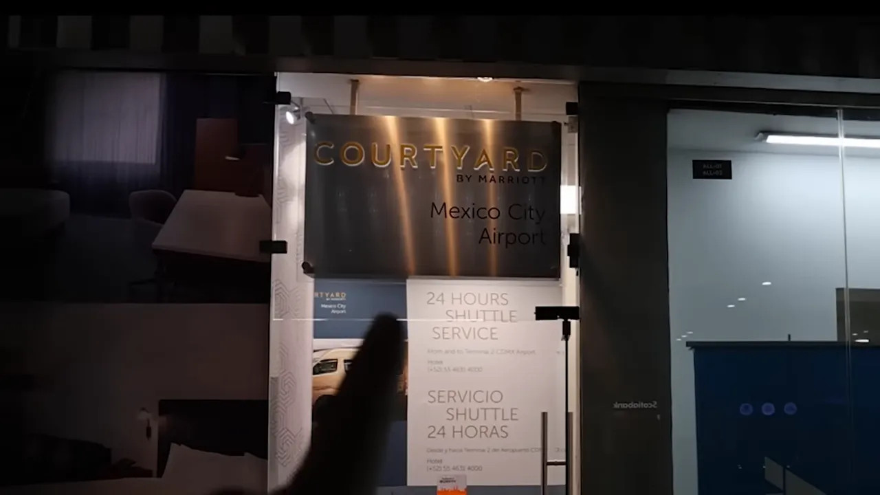 Finger pointing at Courtyard by Marriott shuttle service sign in airport