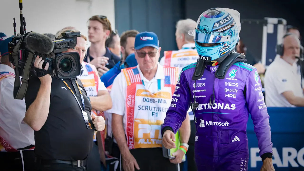 Lewis Hamilton under pressure from TV cameras outside the paddock at the 2026 Miami Grand Prix