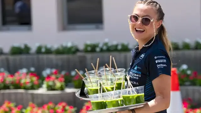 Team members delivering drinks in the paddock