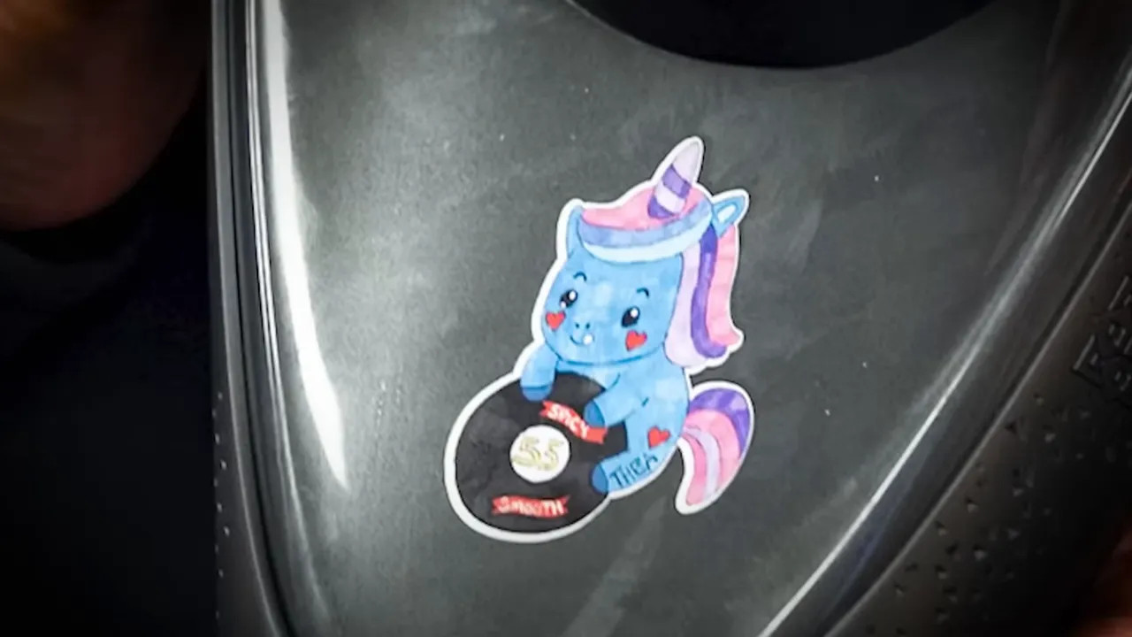 Close-up of the fan-designed sticker on Carlos Sainz's trophy and helmet