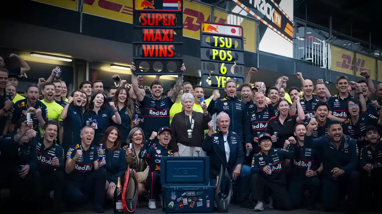 Red Bull team celebrating Max Verstappen's win in the pit lane
