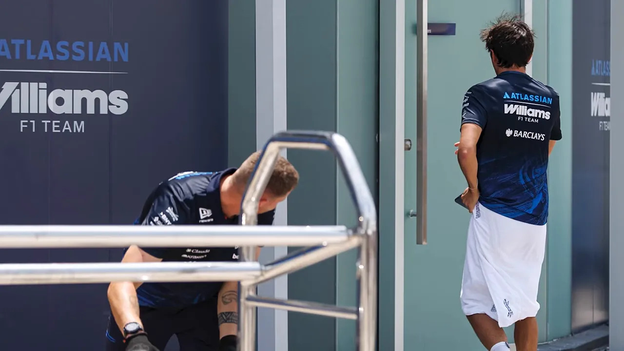 Alex Albon wearing a towel outside the Williams hospitality building