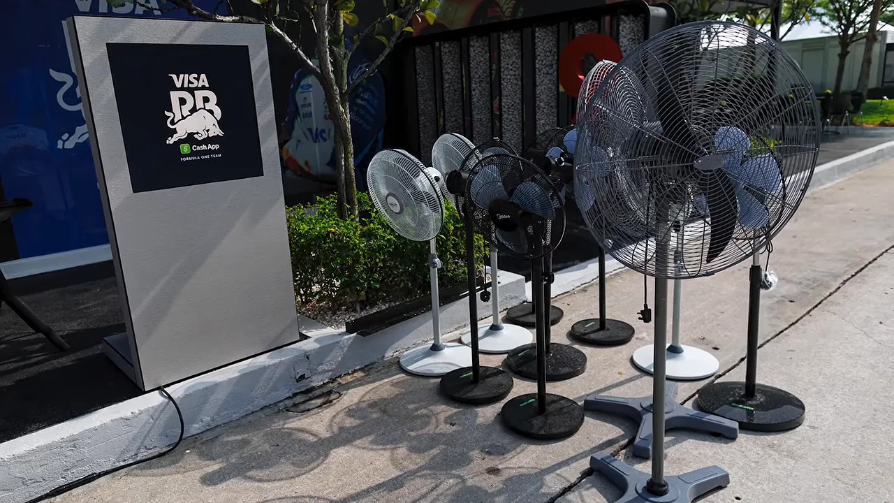 Several pedestal fans arranged outside the Racing Bulls hospitality area