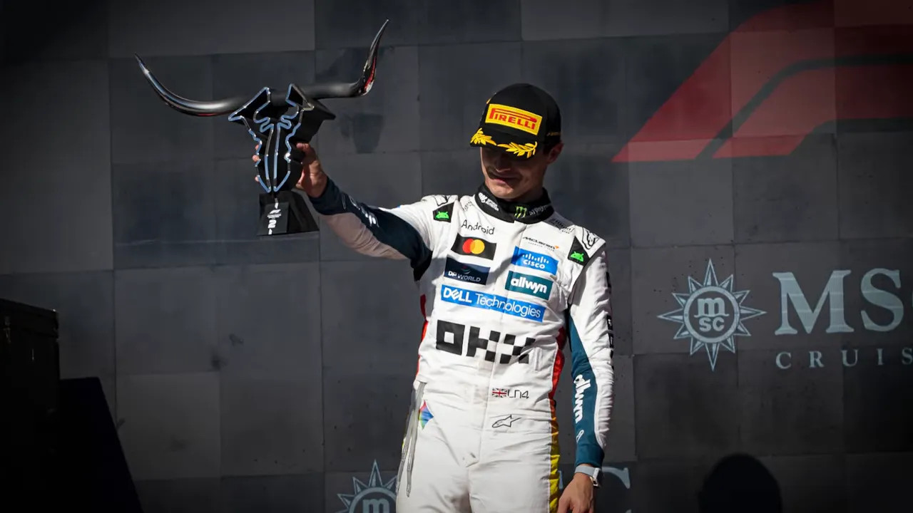 Carlos Sainz on the podium with the big bullhead trophies
