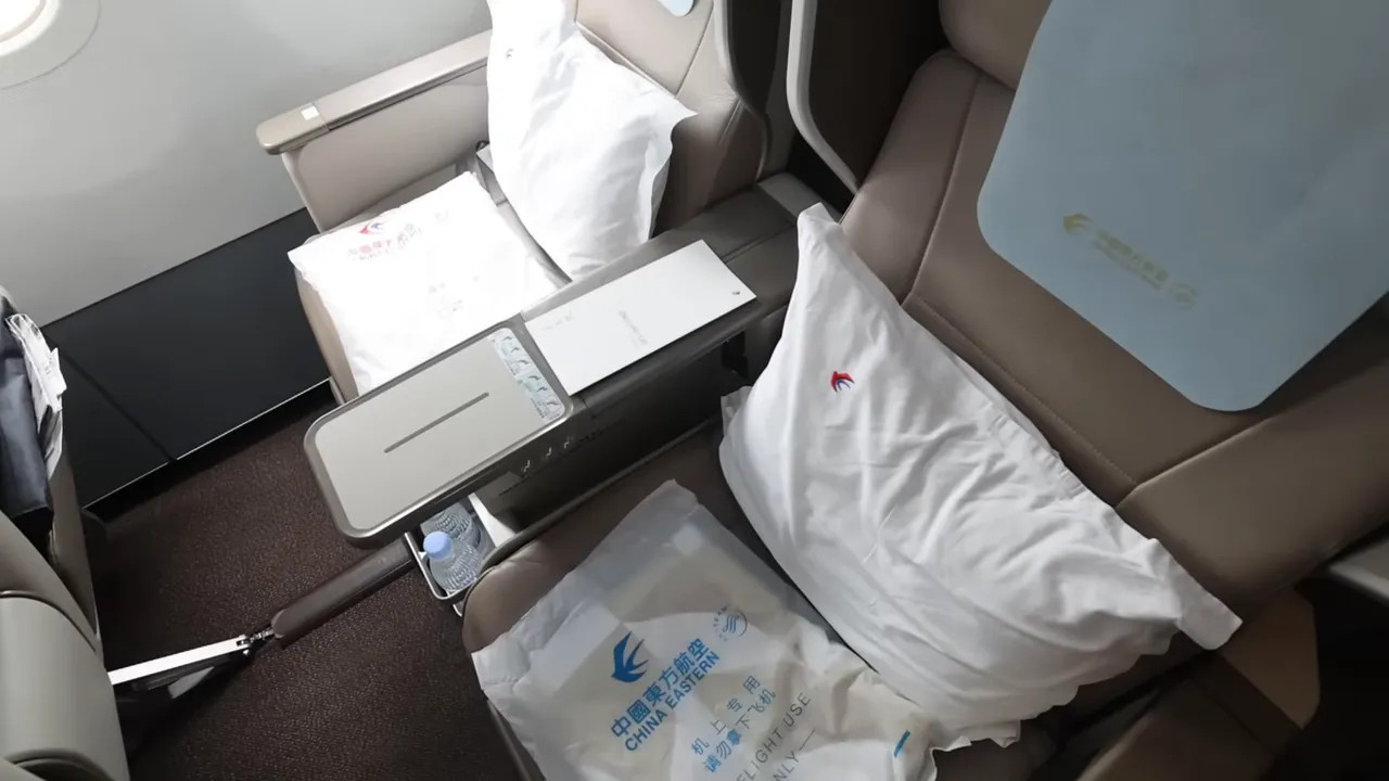 China Eastern business class seats with table tray and welcome bedding