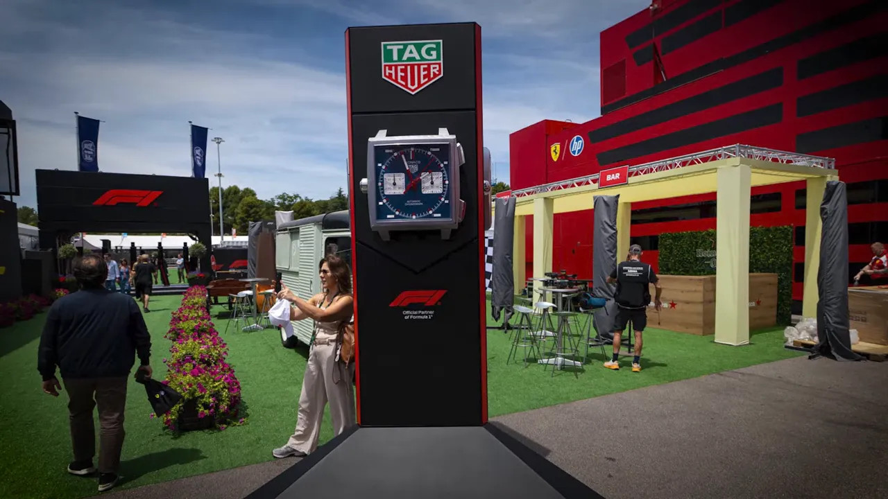 large Tag Heuer clock standing in paddock near Ferrari hospitality
