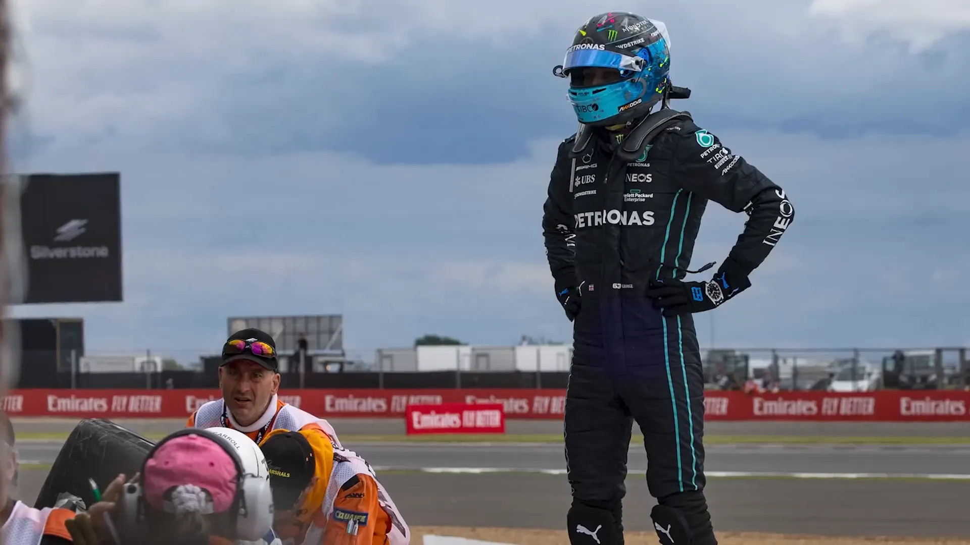 George Russell checks on Zhou Guanyu after crash