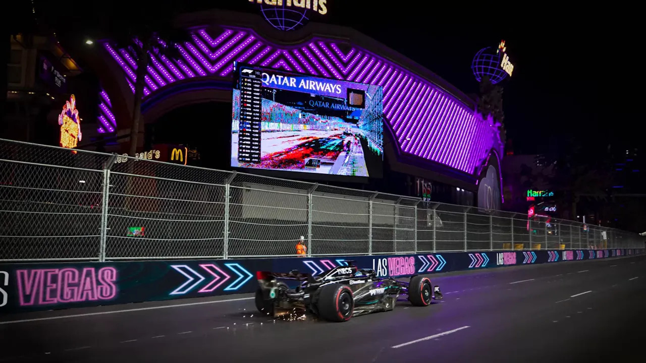 F1 car racing at night on the Las Vegas Strip circuit