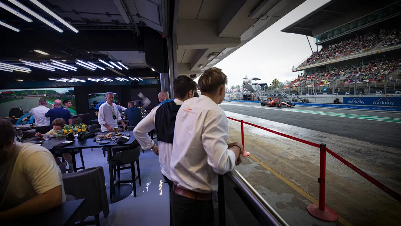 Hospitality dining area overlooking the Las Vegas F1 track with team members and grandstands