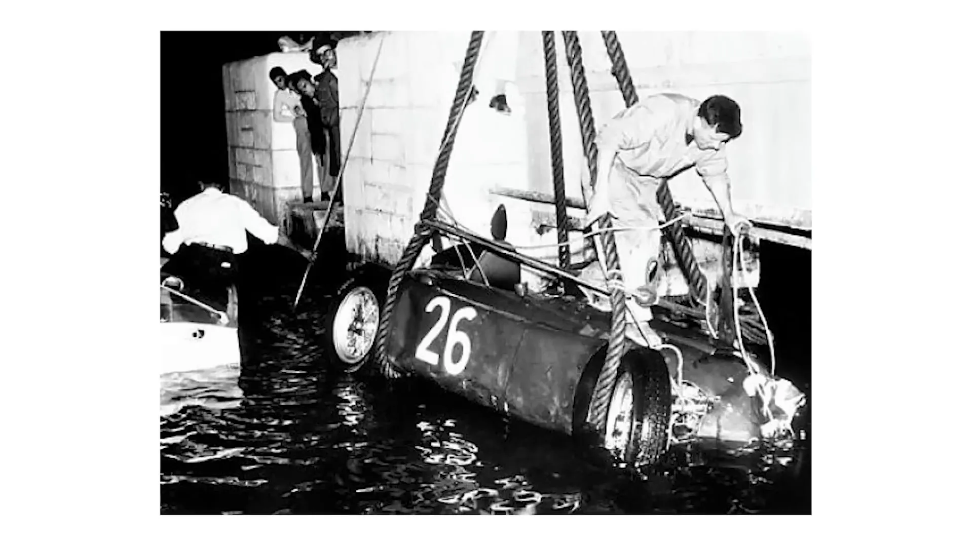 Historical F1 car incident in Monaco Harbor.