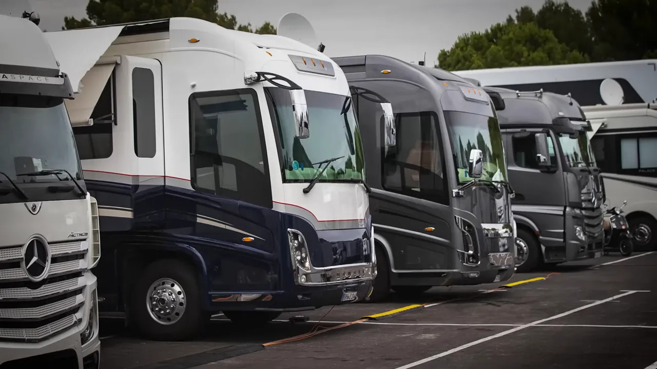 Row of motorhomes parked in a secure paddock area