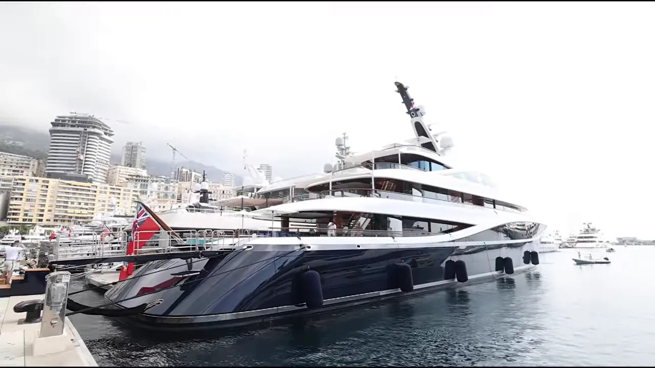 Massive black and white superyacht moored in Monaco harbour