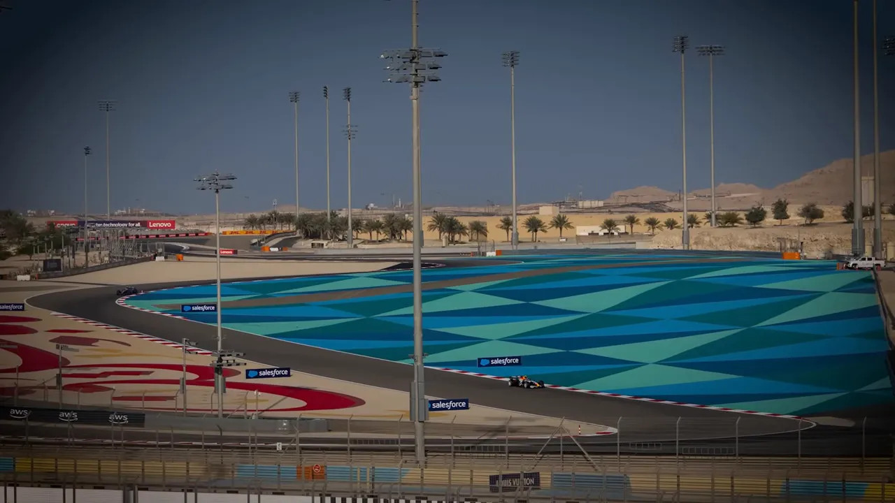 Bahrain circuit run-off area and F1 cars during testing under clear skies