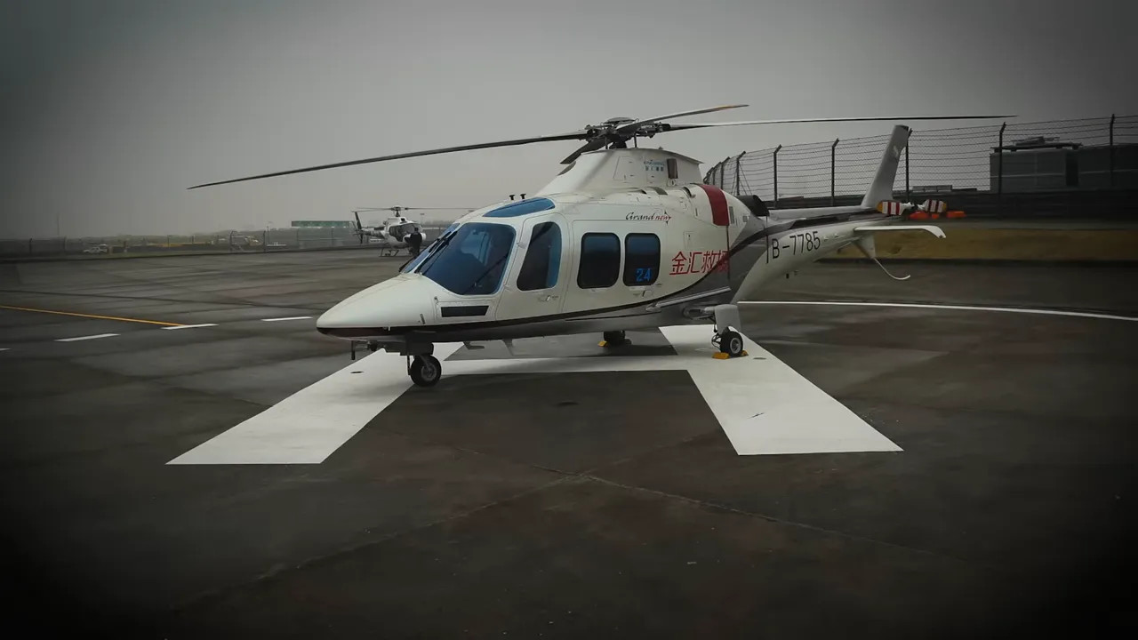 Helicopter parked on a circuit helipad with overcast sky and runway markings