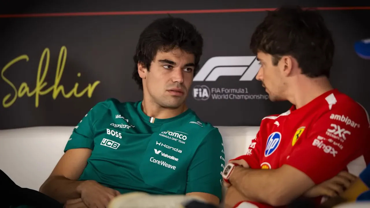 Two drivers in conversation on a sofa with the F1 and Sakhir backdrop behind them.