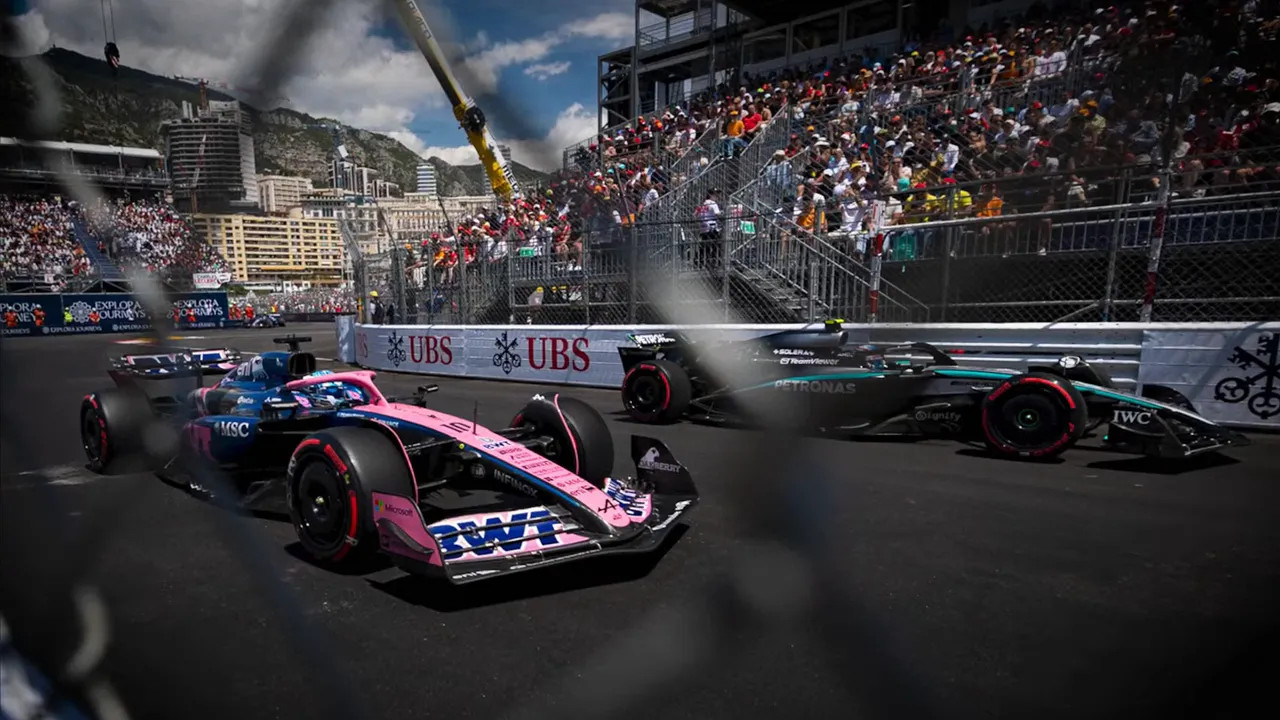 Two Formula 1 cars running side-by-side at a street circuit with grandstands