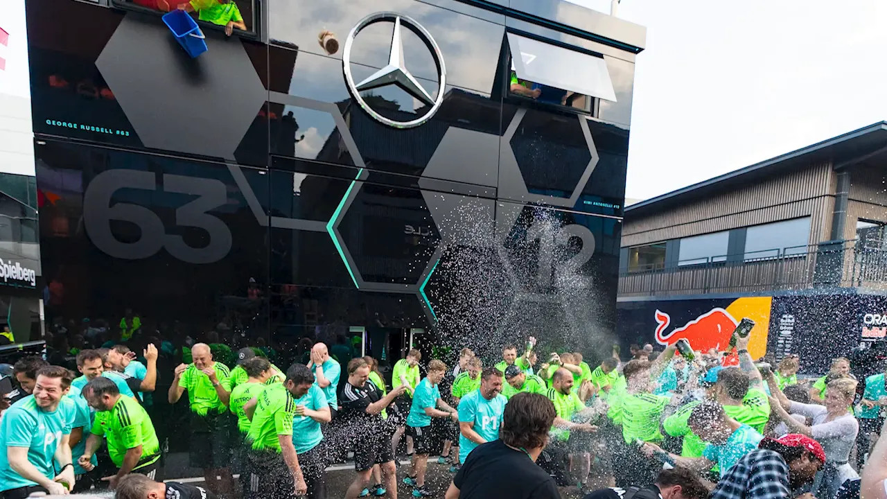 Mercedes motorhome with water pouring down from an upper window onto the celebration below
