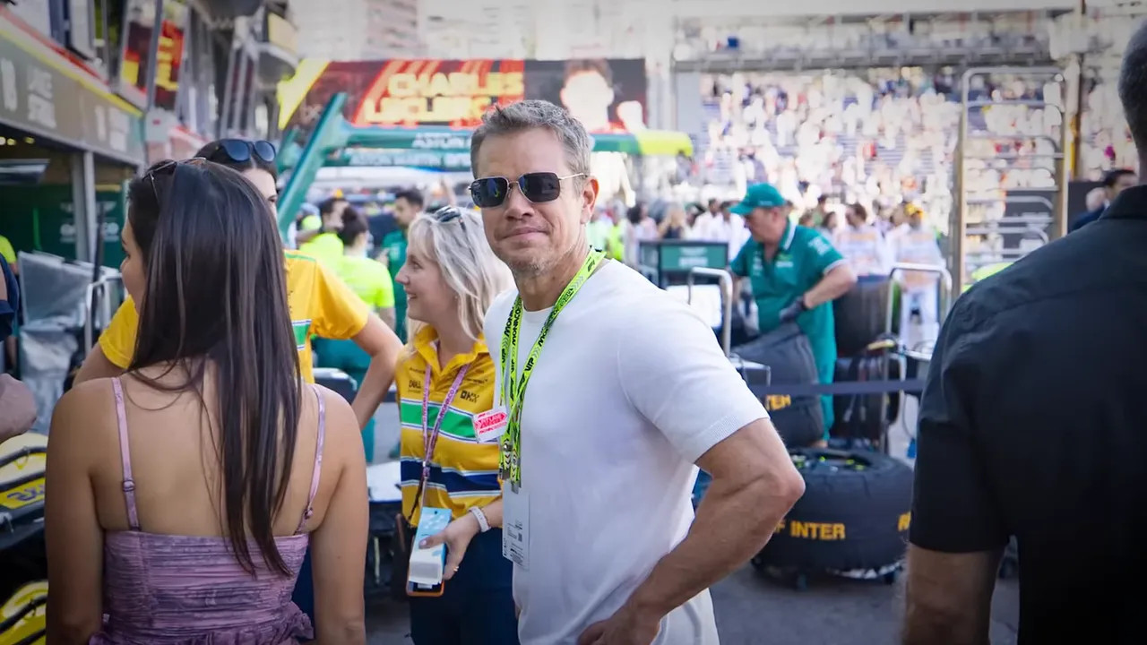 Celebrity guests and team principals in the paddock
