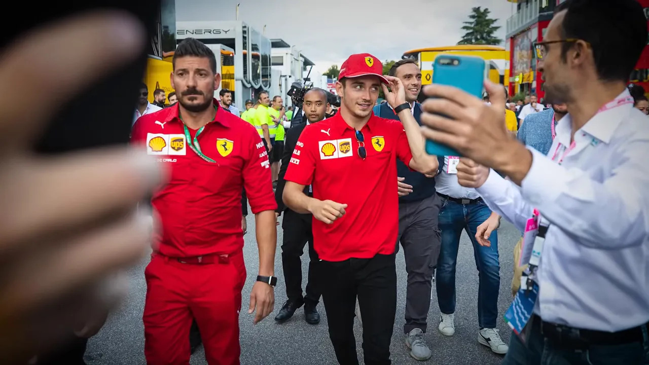 Fan rushing up to grab a driver for a photo