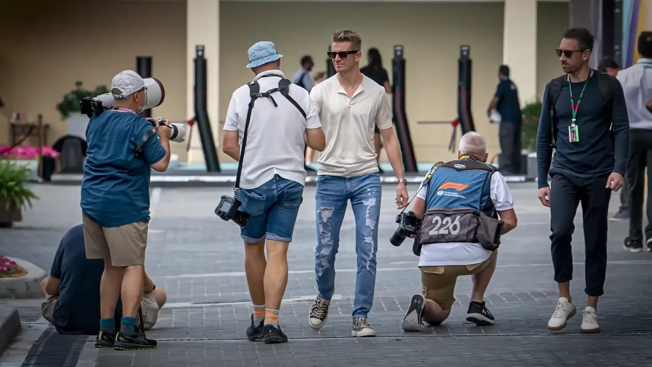 Photographers working in the crowded paddock