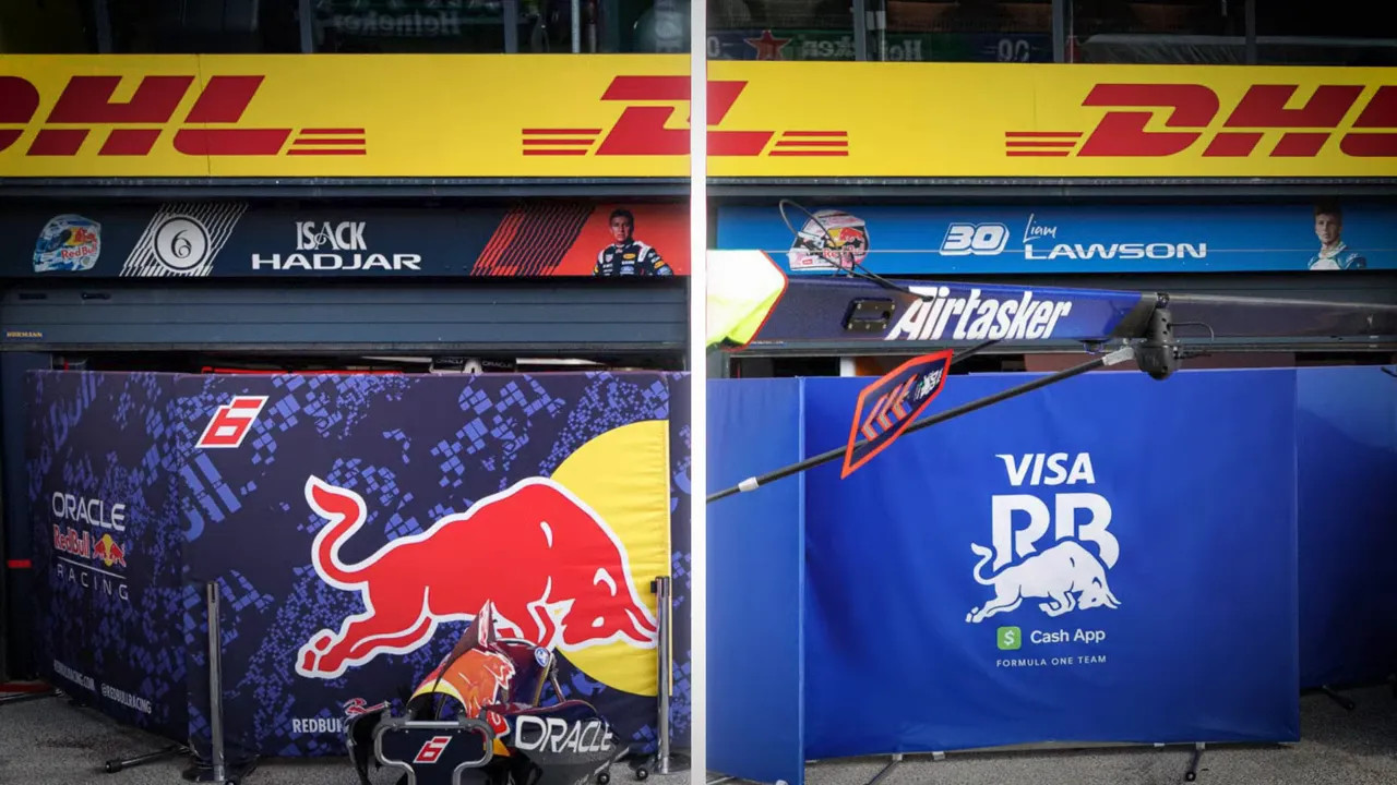 Split garage signage showing Isack Hadjar and Liam Lawson driver names above Red Bull team garages