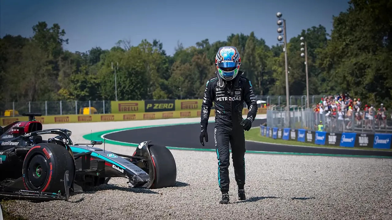 Mercedes Formula 1 driver walking away from a stopped car in the gravel at Monza