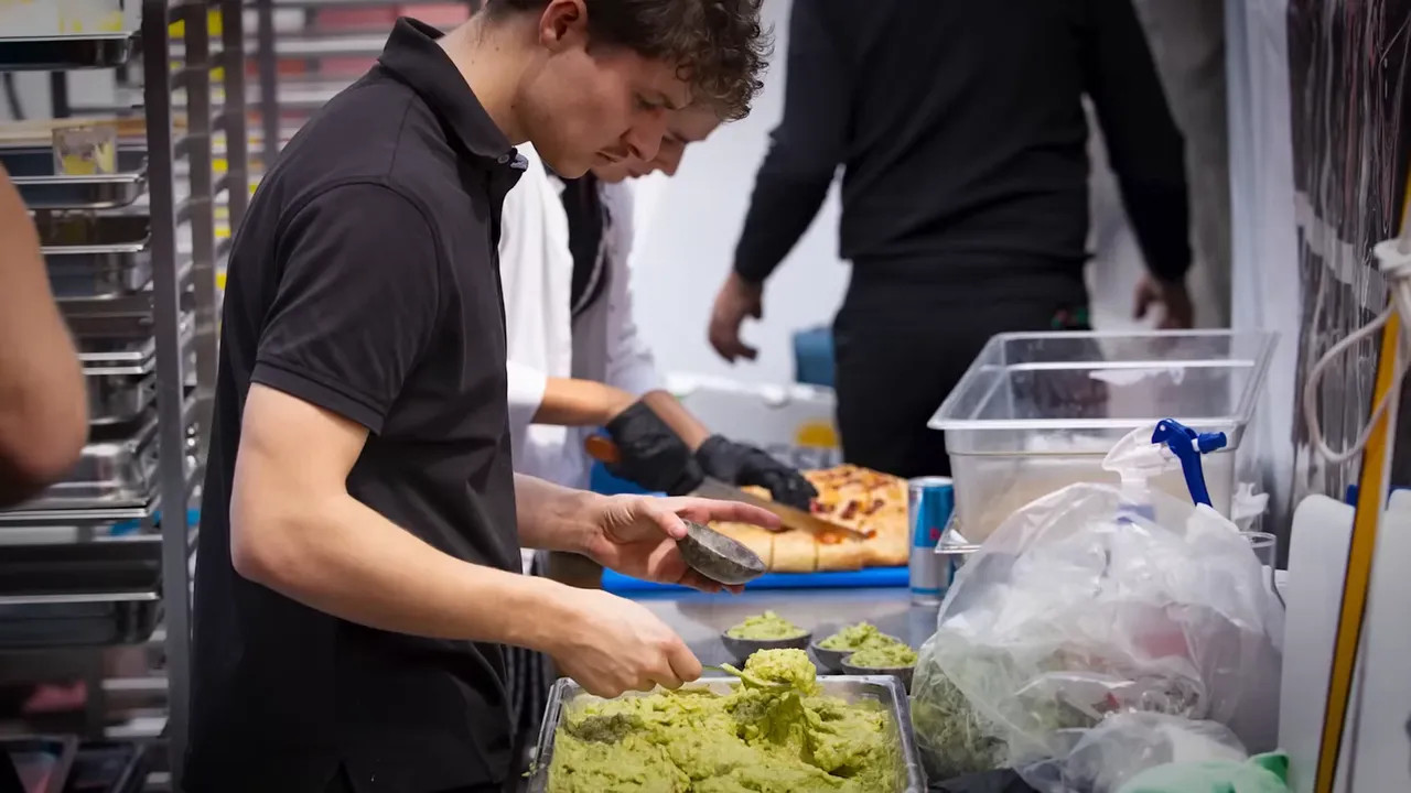 Hospitality staff serving guests inside a team hospitality unit