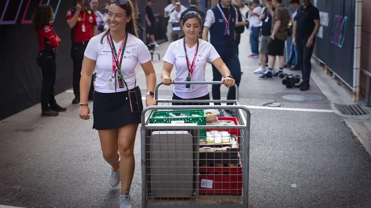 Hospitality staff working inside a team motorhome