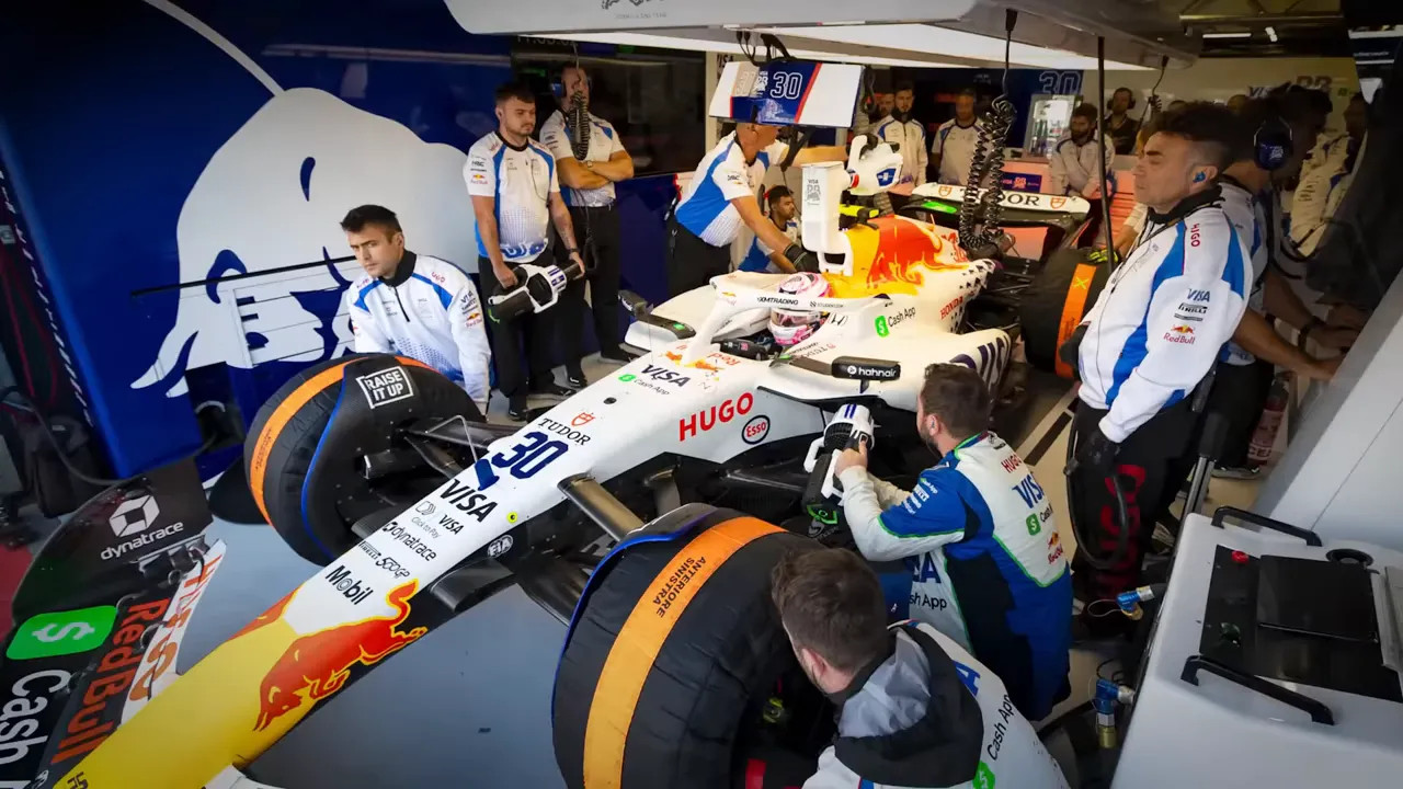 Mechanics working on an F1 car in the garage