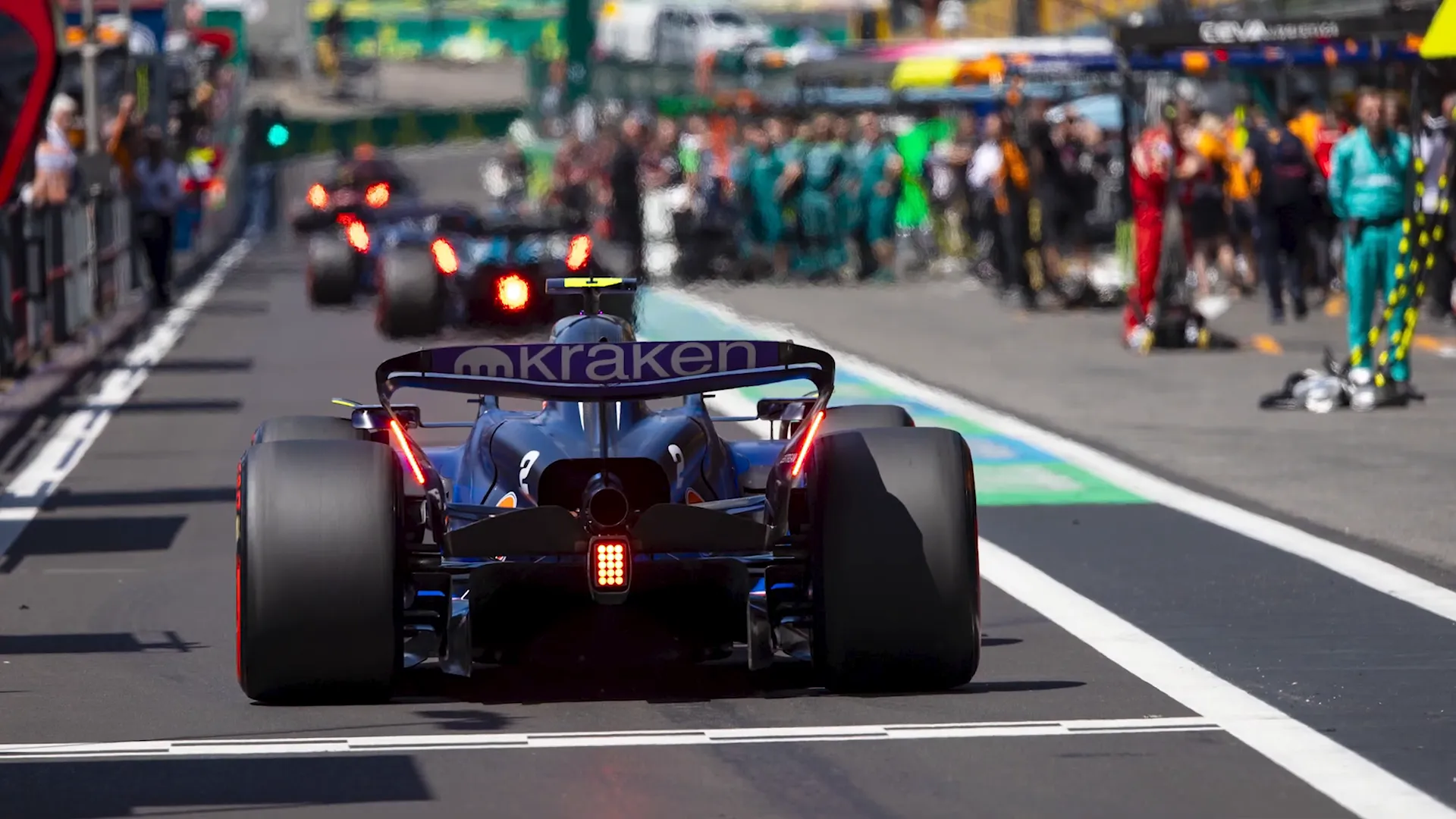 F1 cars leaving garages