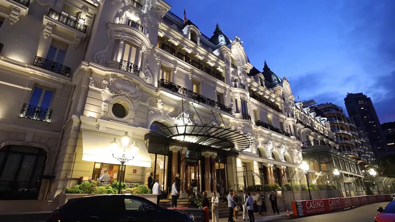 Illuminated facade of the Hotel de Paris in Monaco at dusk