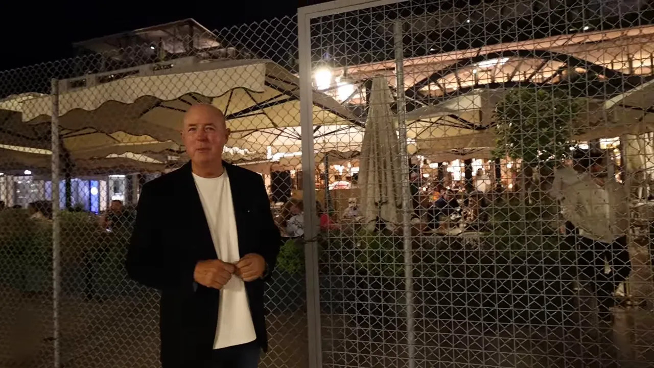 Restaurant terrace behind chain link fencing along the Monaco street circuit