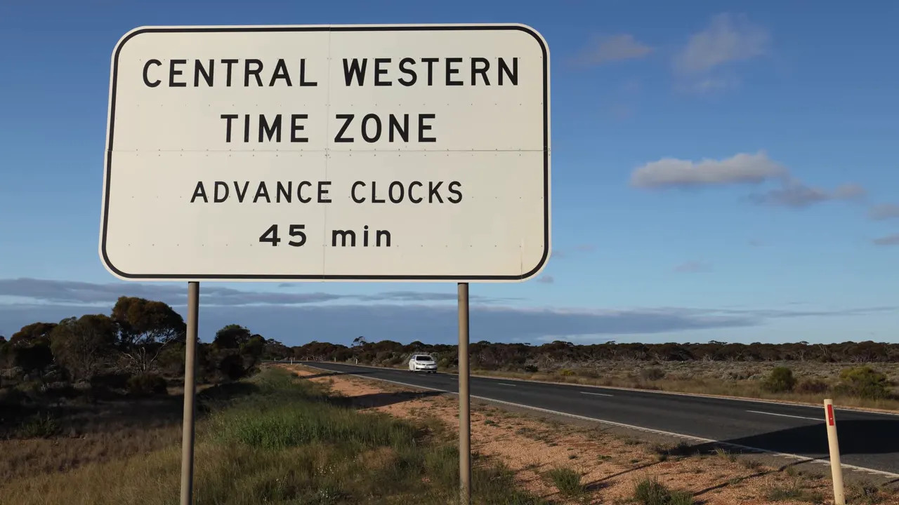 Central Western Time Zone sign stating advance clocks 45 minutes