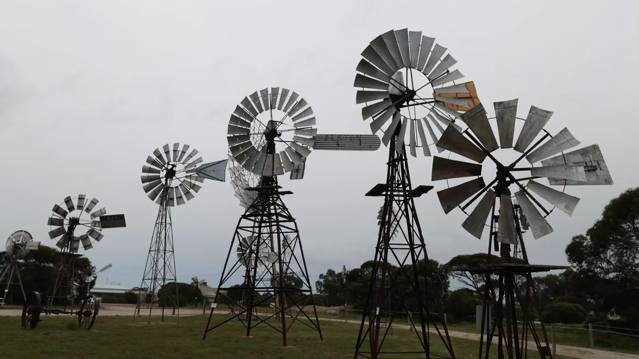 Collection of historic windmills in Penong under an overcast sky