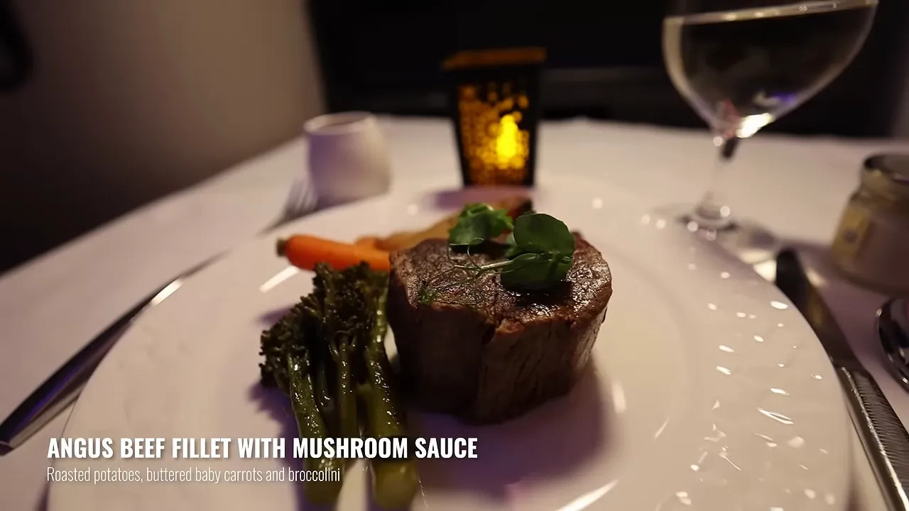 Angus beef fillet with vegetables and mushroom sauce on a white tablecloth