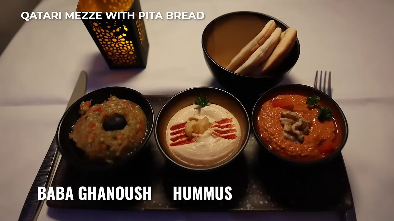 Qatari mezze tray with baba ganoush hummus muhammara and pita bread