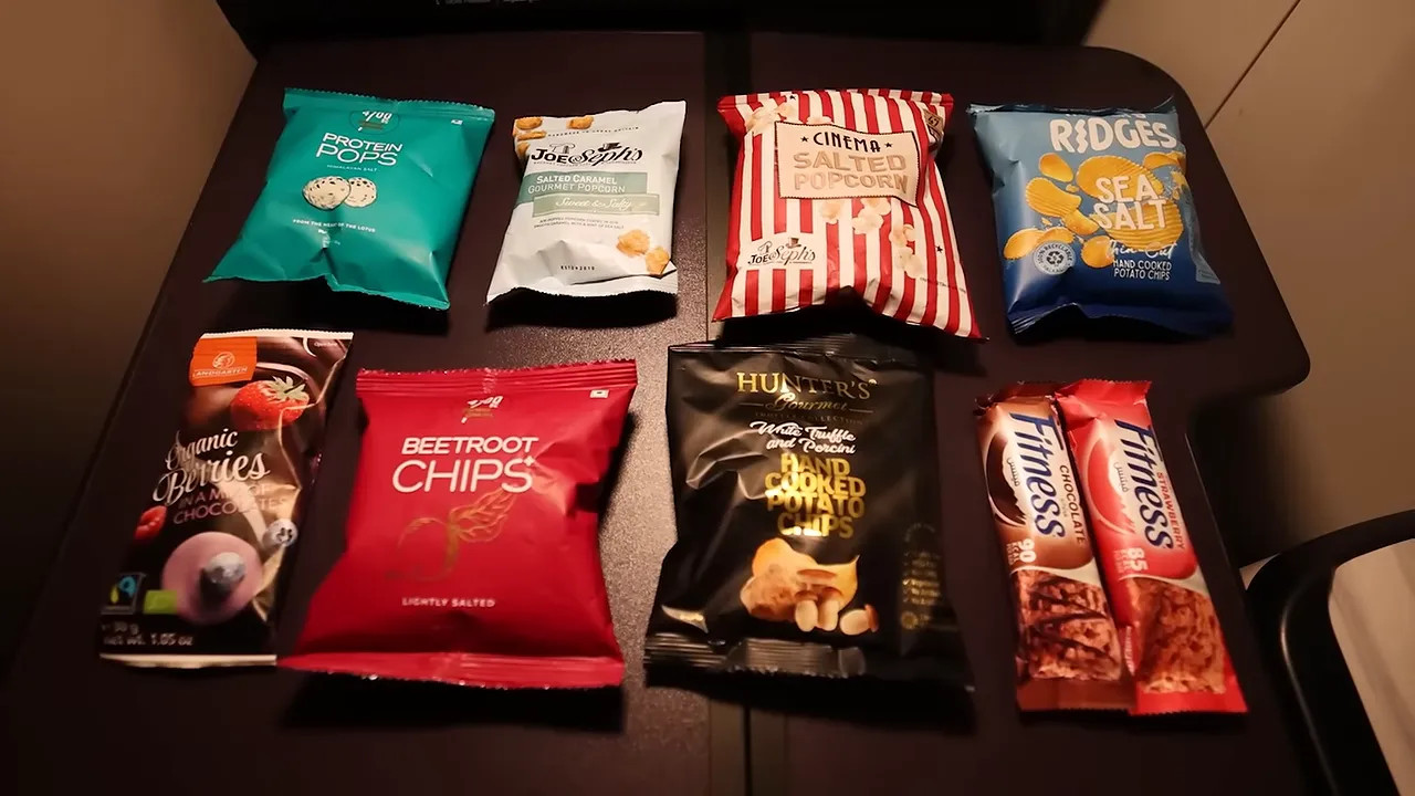Selection of packaged snacks arranged on a tray table